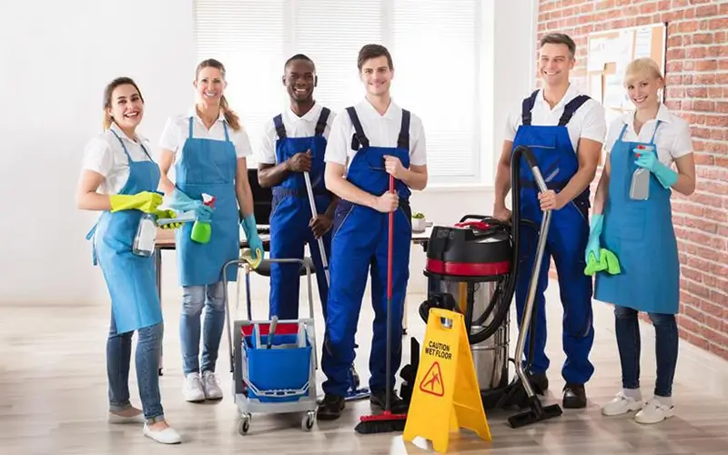 team of cleaners grouped up to pose for photo, About, Car Dealerships, Day Care Facilities, Gyms, Porter, Power Washing,